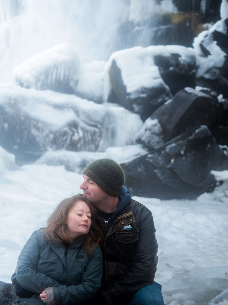 Couple photoshoot in winter with frozen waterfall