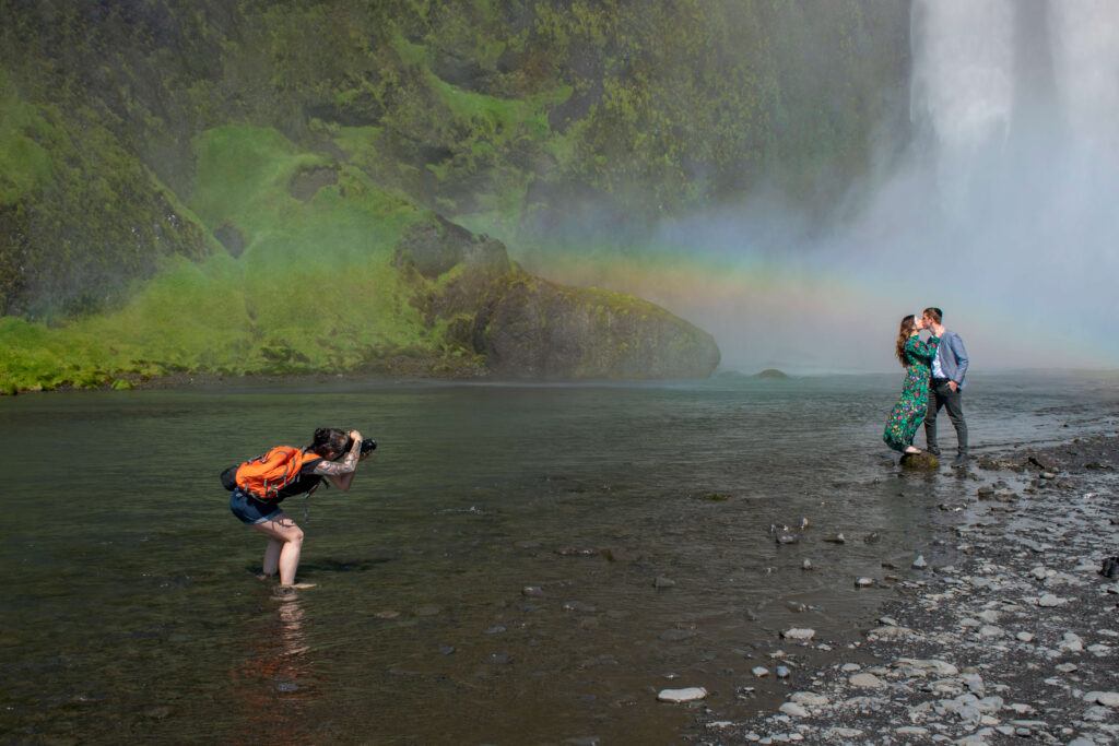 Local wedding photographer in Ieland Kat Deptula is making photo of the couple in front of the waterfall