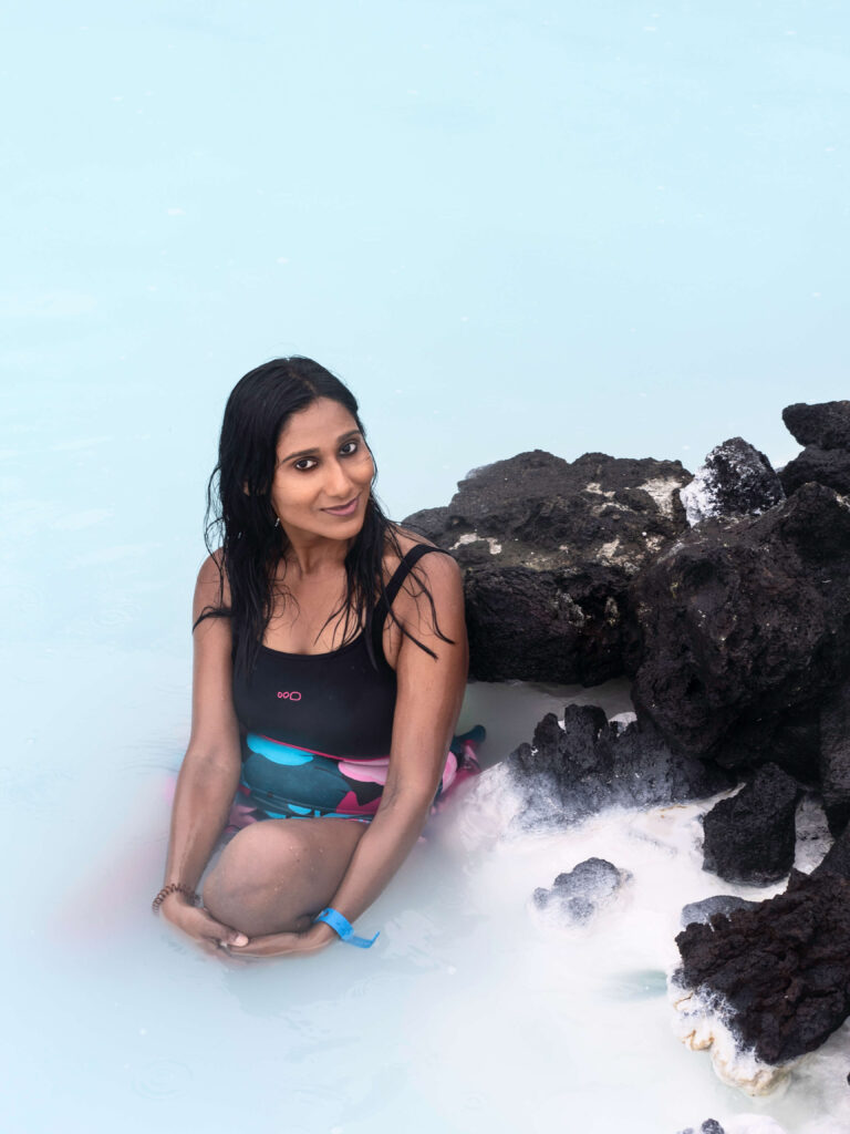 girl in the swim suit sitting in the water in blue lagoon iceland