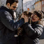 couple petting the cat n the street